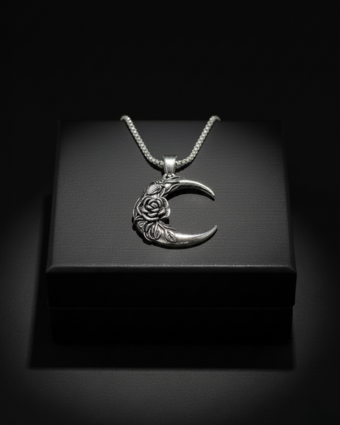 Silver crescent Midnight Rosemoon Pendant with floral design on a black box