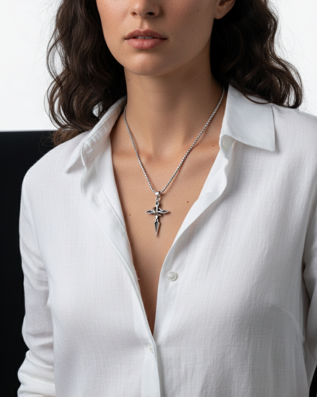 Woman wearing a white shirt with a necklace featuring a Night's Compass Pendant.