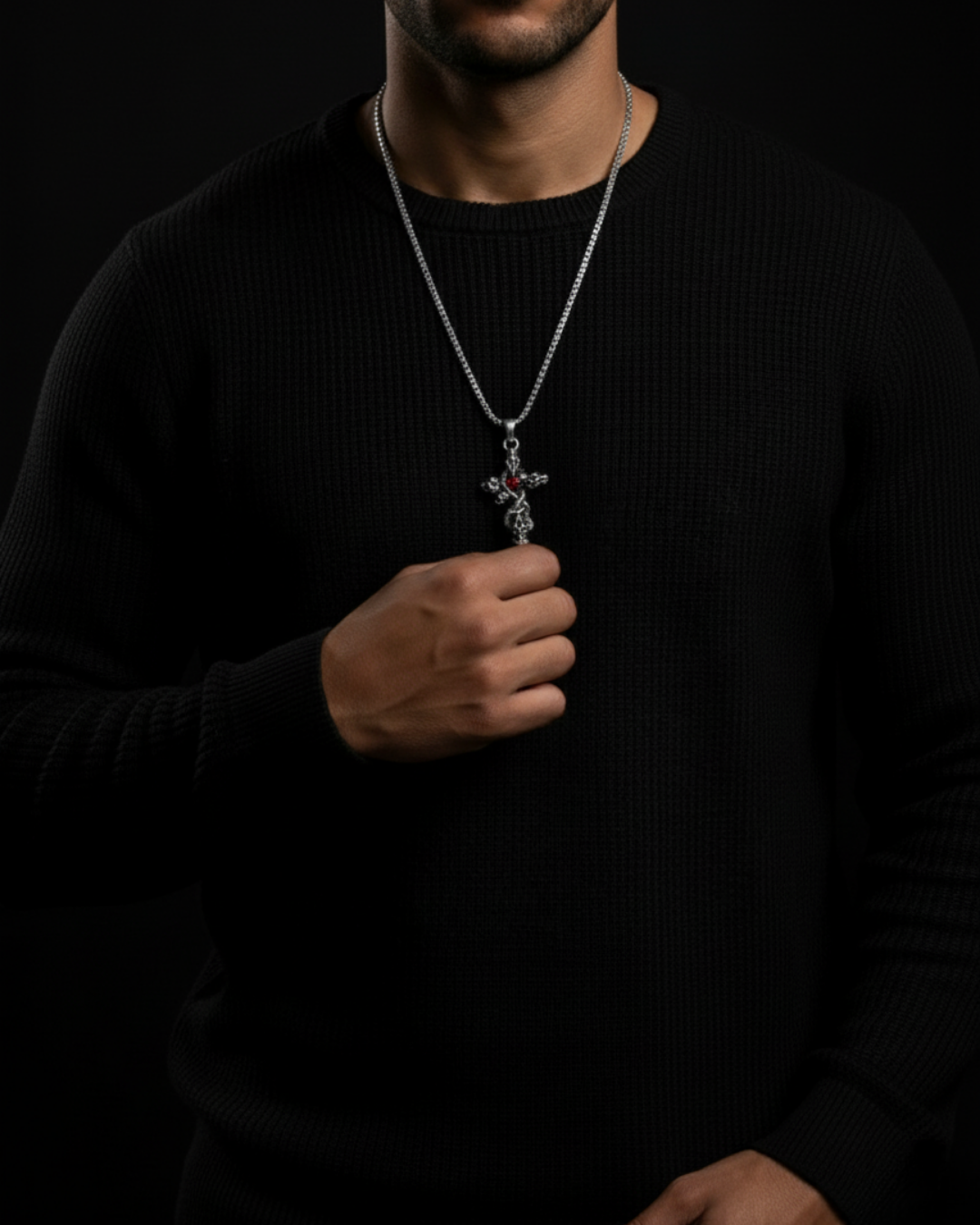 Person wearing a black sweater with a necklace featuring a Skull Cross Pendant on a dark background