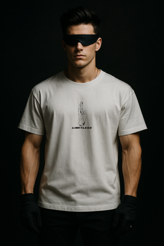 Man wearing a white t-shirt with a logo and text, standing against a dark background