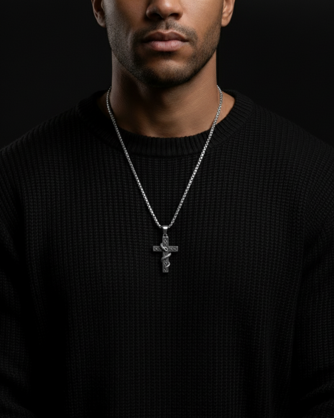 Man wearing a black sweater with a Veritas Serpent Pendant against a black background