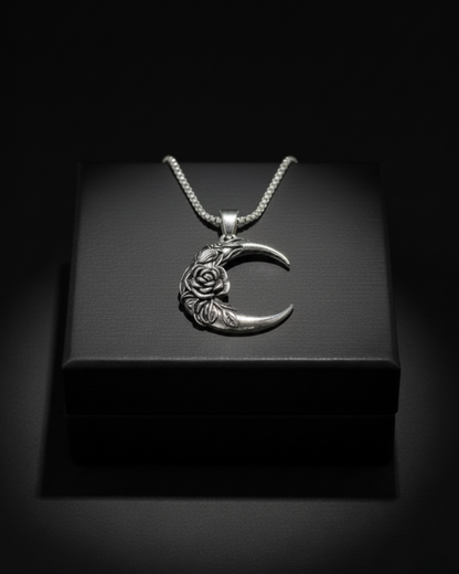 Silver crescent Midnight Rosemoon Pendant with floral design on a black box